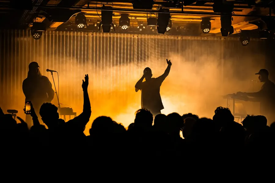 Silhouetten der Künstler im gelben Nebel, Publikum mit erhobenen Händen – Soukey & Stereo Luchs live im Salzhaus Winterthur, 2025